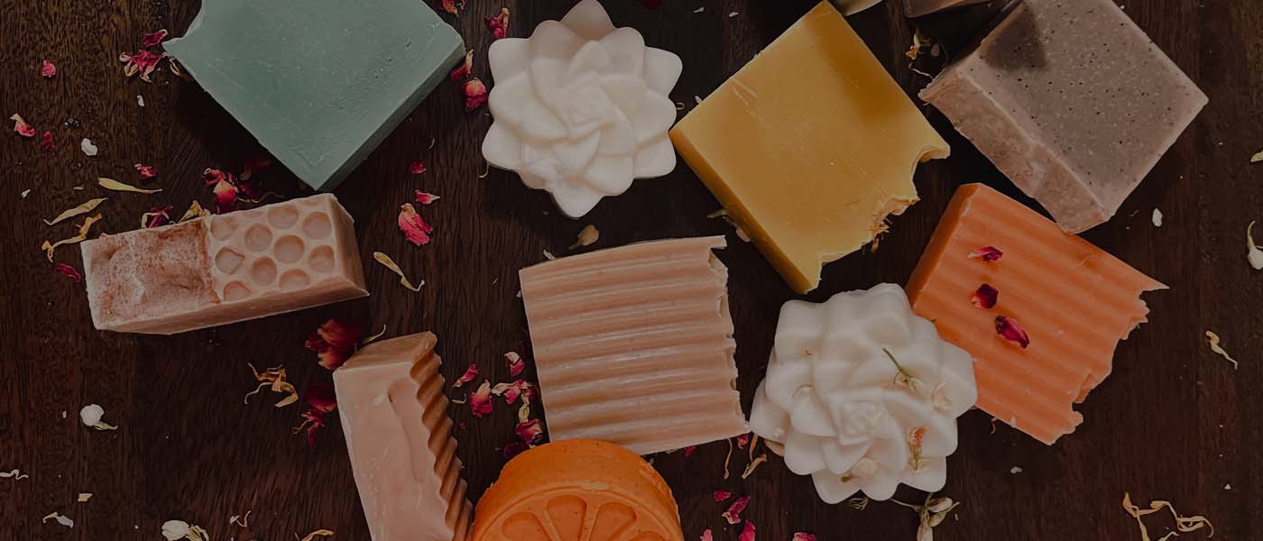 Swiney Soaps header image with display of soap bars